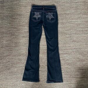 Black flare jeans with rhinestone star design on the back pockets